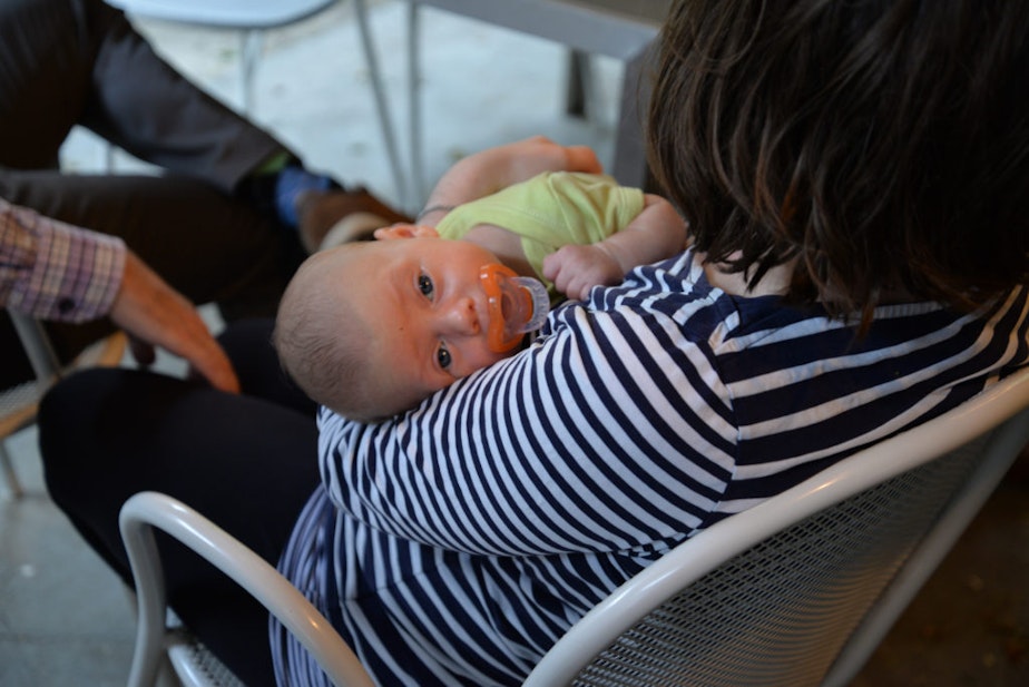 caption: New mom Nicole Minkoff holds her seven week old baby boy at home in Seattle.