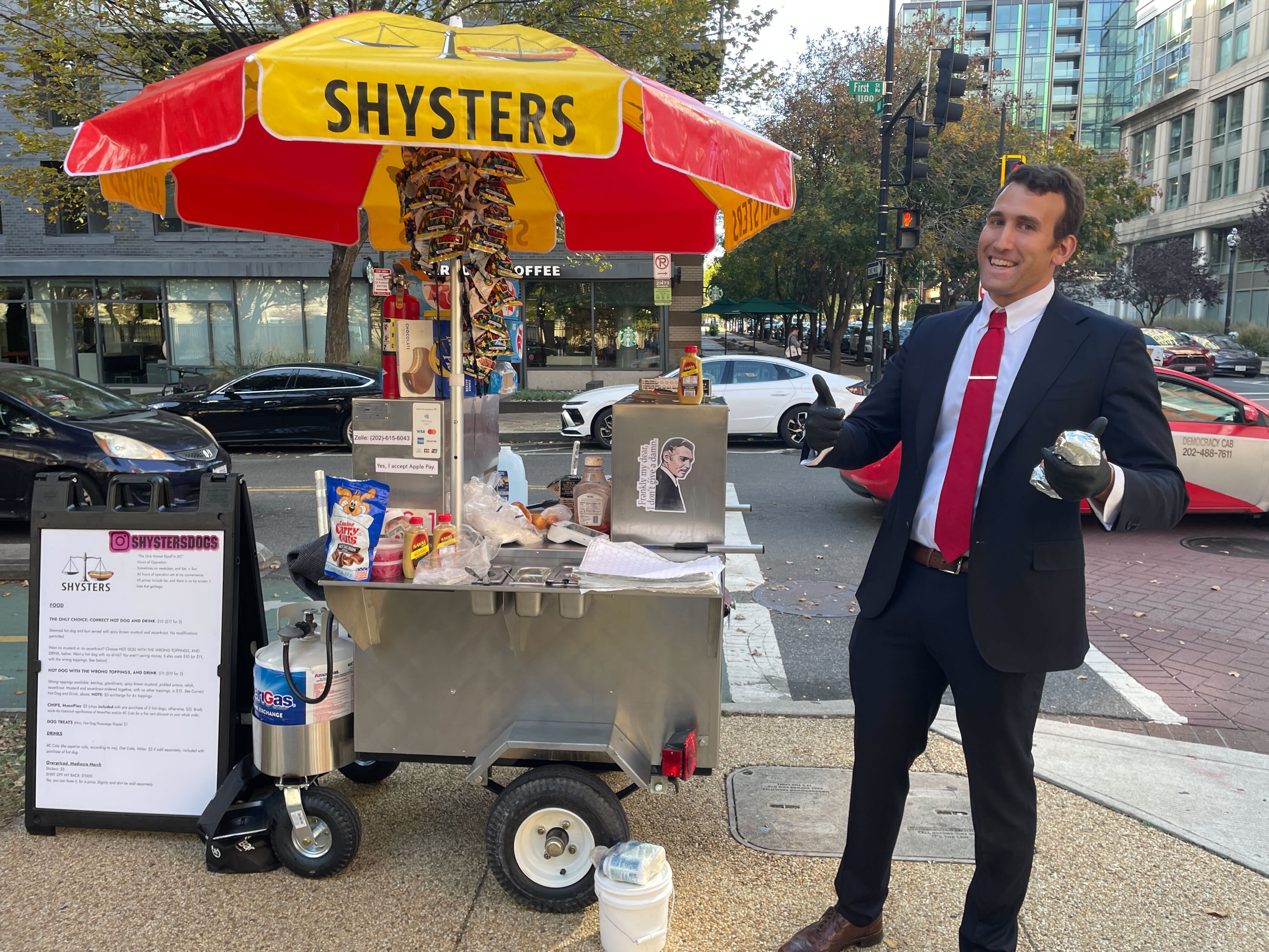 caption: Isaac Stein stands outside "Shysters Dogs" on Sunday.