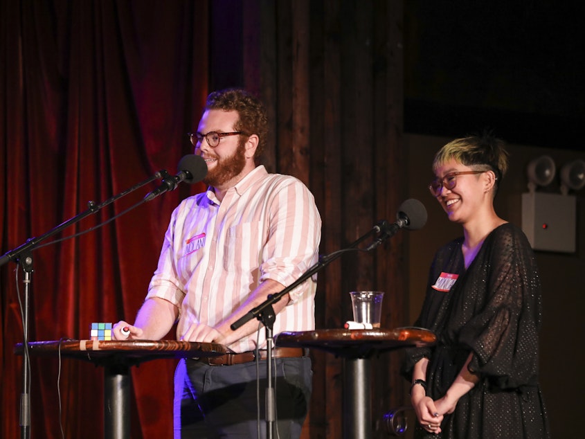 caption: Contestants compete in <em>Ask Me Another</em>'s final round at the Bell House in Brooklyn, New York.