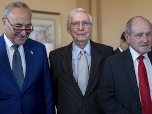 caption: Senate Minority Leader Mitch McConnell, R-Ky., center, is joined by Senate Majority Leader Chuck Schumer, D-N.Y., left, and Senate Foreign Relations Committee Ranking Member Jim Risch, R-Idaho, right, on July 27. On Wednesday McConnell appeared to freeze while talking to reporters at a Kentucky event.
