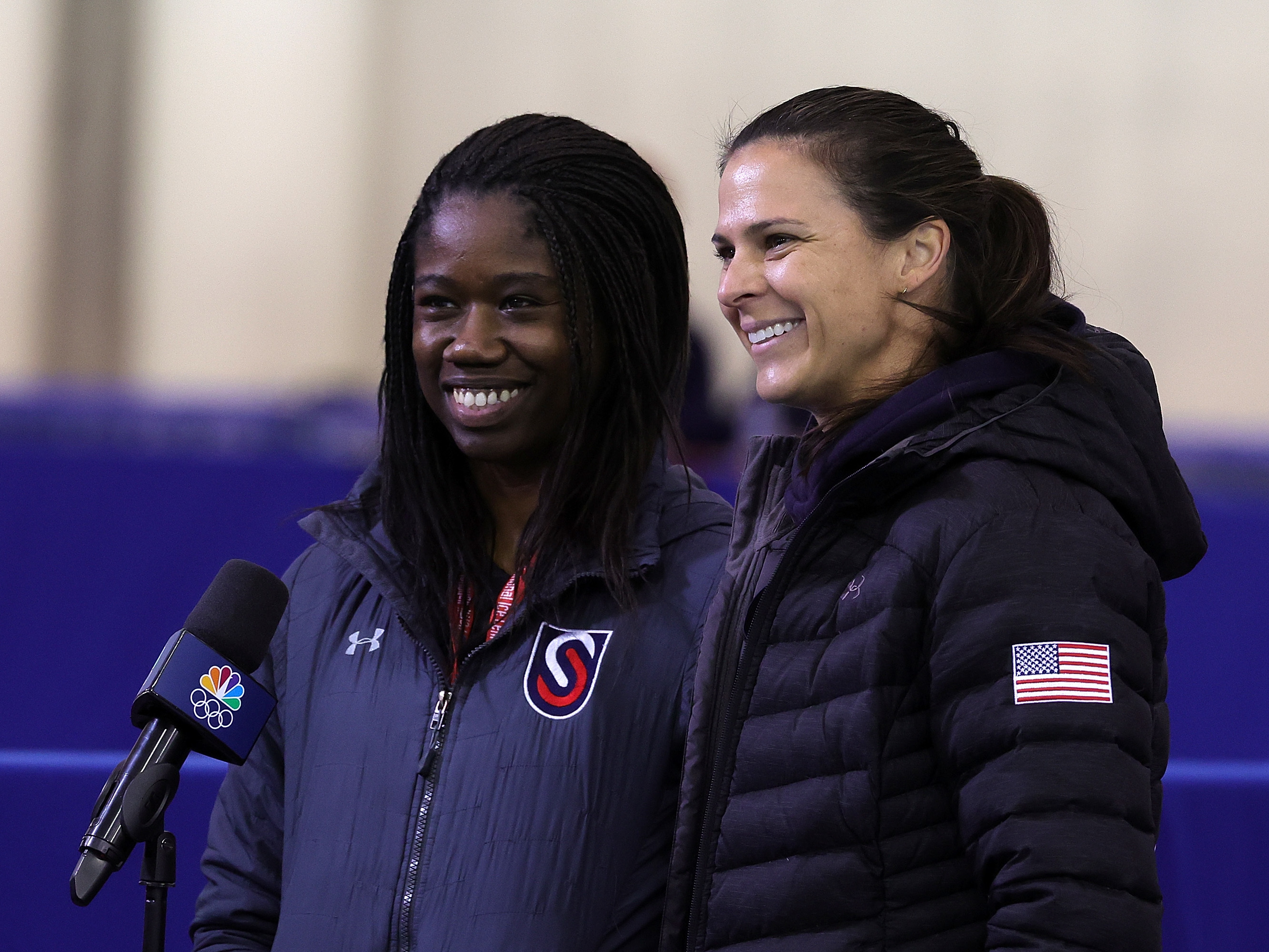 caption: Erin Jackson's teammate Brittany Bowe (right) gave up her spot for the 2022 Beijing Olympics after Jackson was eliminated during trials for women's speedskating. Jackson will be competing in Bowe's place.