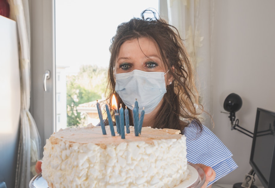 caption: Birthday spoiler alert: If you want your mask to be a barrier to coronavirus transmission, you should not be able to blow out candles while wearing it.