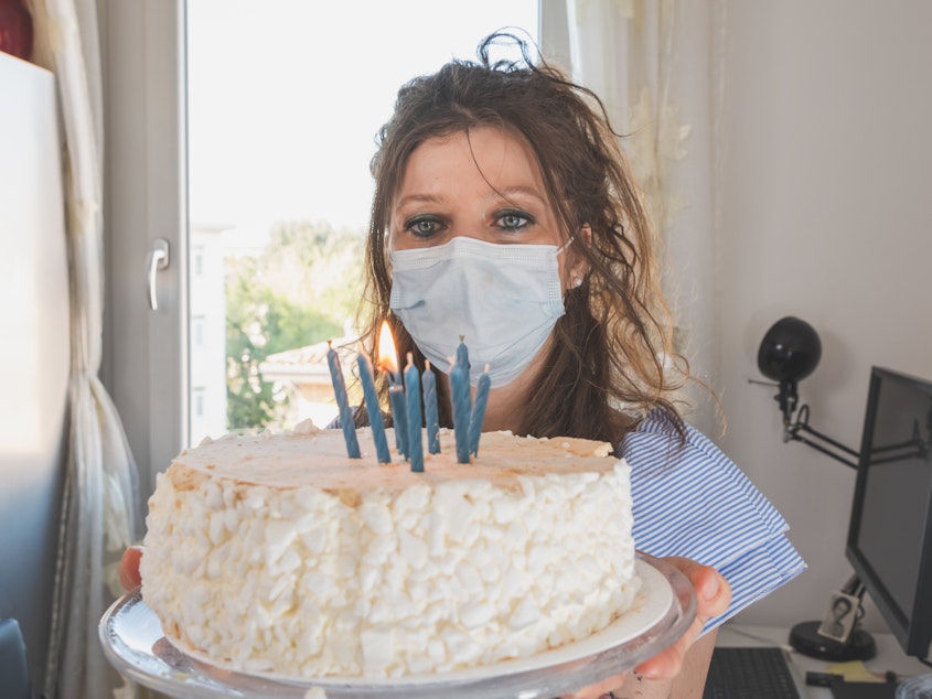 caption: Birthday spoiler alert: If you want your mask to be a barrier to coronavirus transmission, you should not be able to blow out candles while wearing it.