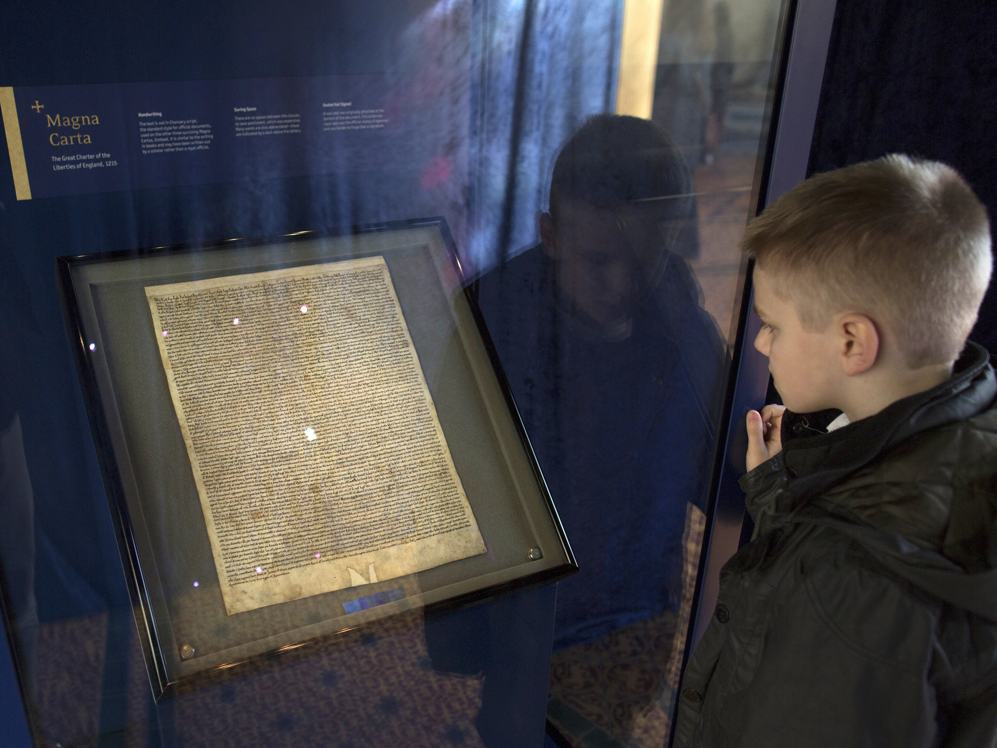 caption: British police say a man tried to steal the Salisbury Cathedral's Magna Carta, one of four original documents that have survived. Here, a schoolboy looks at the Magna Carta in the cathedral's Chapter House.