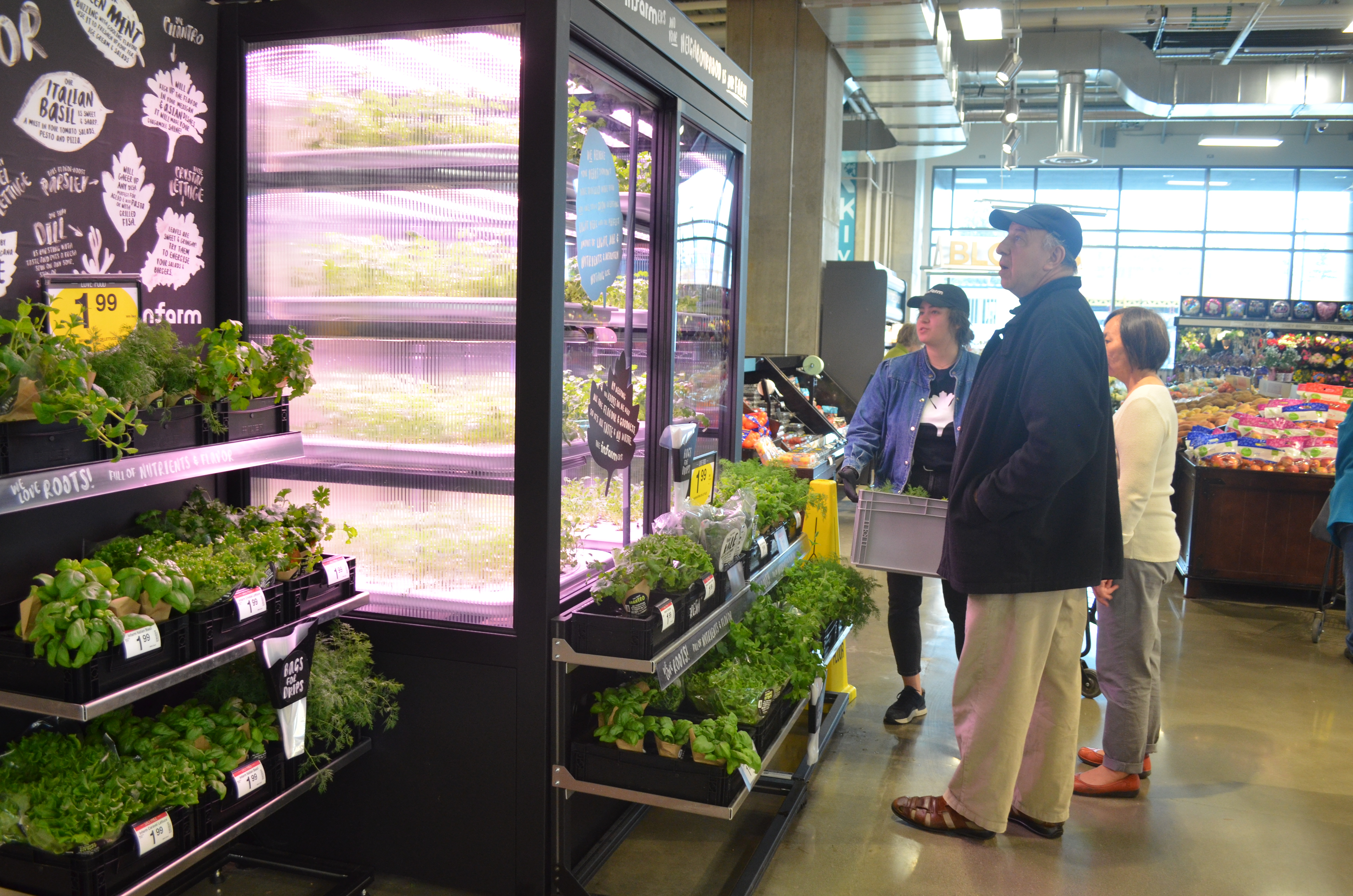 caption: InFarm employee Melaina Beyer explains vertical farming to customers at a Kirkland QFC.