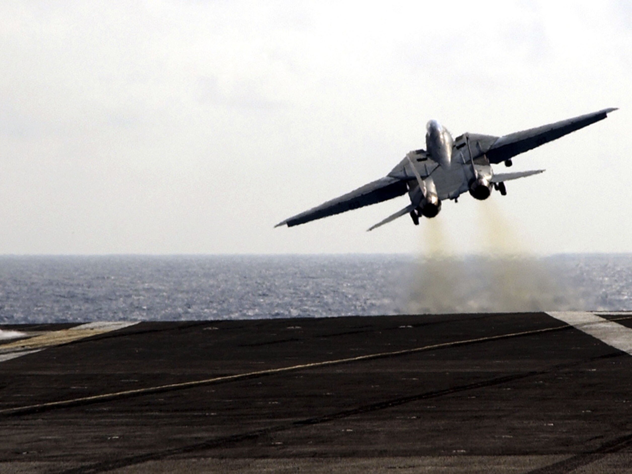 caption: The final catapult launch of the F-14 Tomcat fighter aircraft aboard the USS Theodore Roosevelt on July 28, 2006. The U.S. military retired the plane that year.