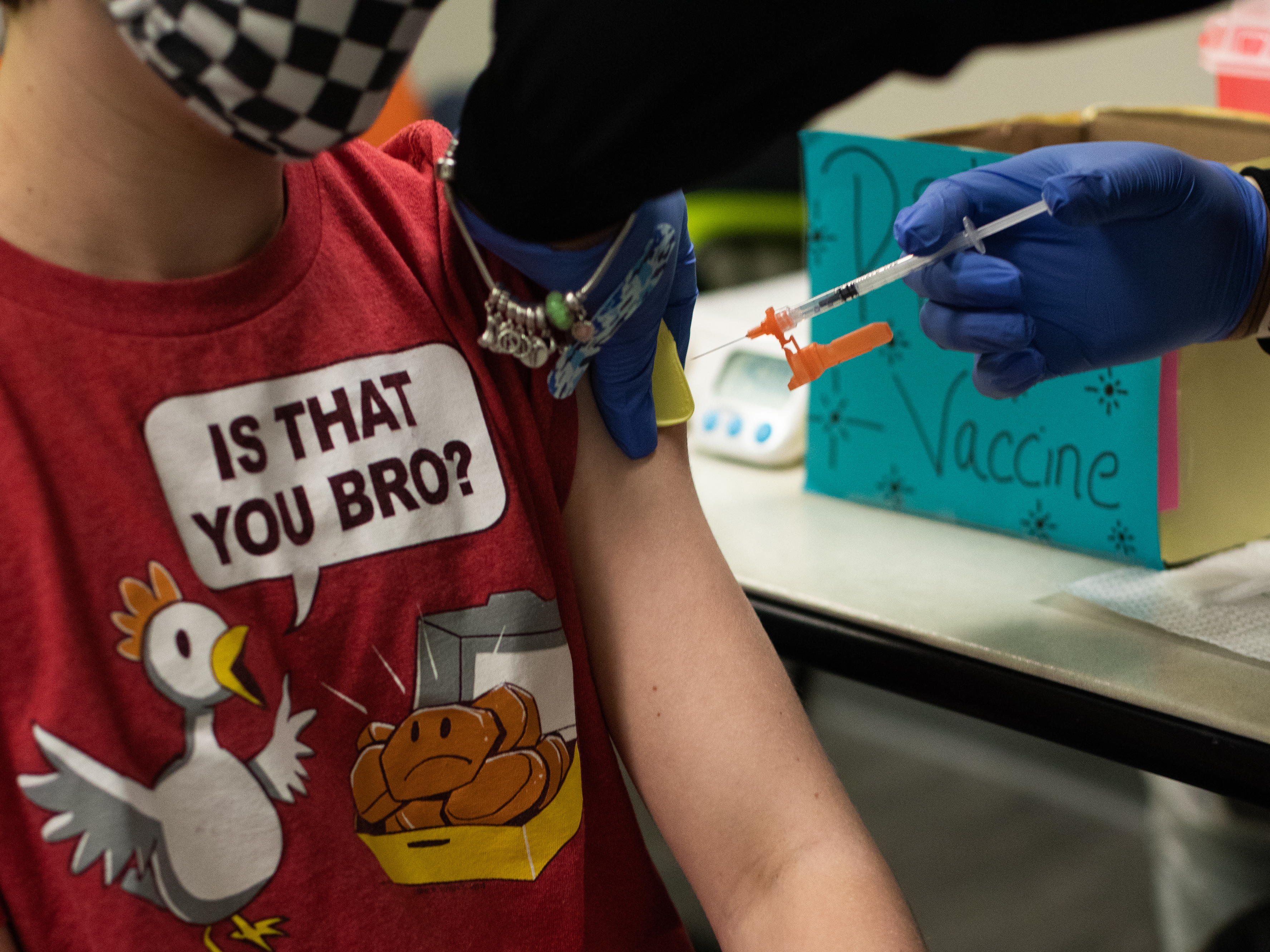 caption: An older child gets vaccinated in Michigan. Pfizer and BioNTech say they will submit a formal request for emergency use authorization of the vaccine in children as young as 5 in the coming weeks.
