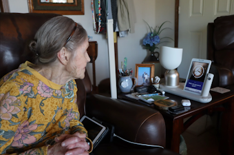 caption: Jan Worrell, 83, and her AI-powered companion robot named ElliQ interact throughout the day at her home on the Long Beach Peninsula.