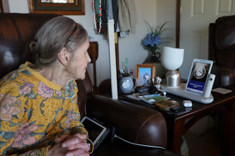 caption: Jan Worrell, 83, and her AI-powered companion robot named ElliQ interact throughout the day at her home on the Long Beach Peninsula.