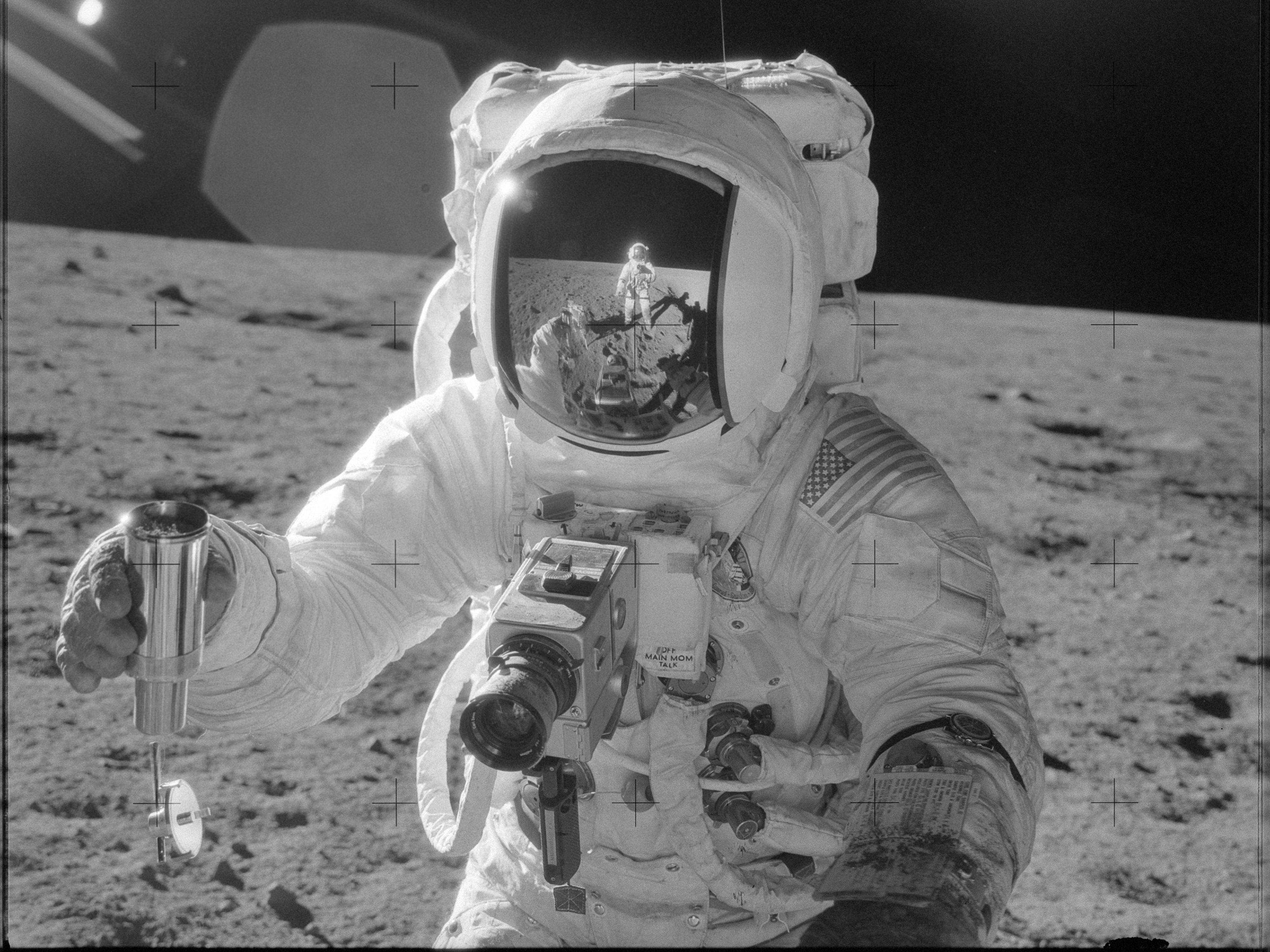 caption: Astronaut Alan L. Bean holds a container filled with lunar soil collected during the extravehicular activity in which astronauts Charles Conrad Jr., commander, and Bean, lunar module pilot, participated.