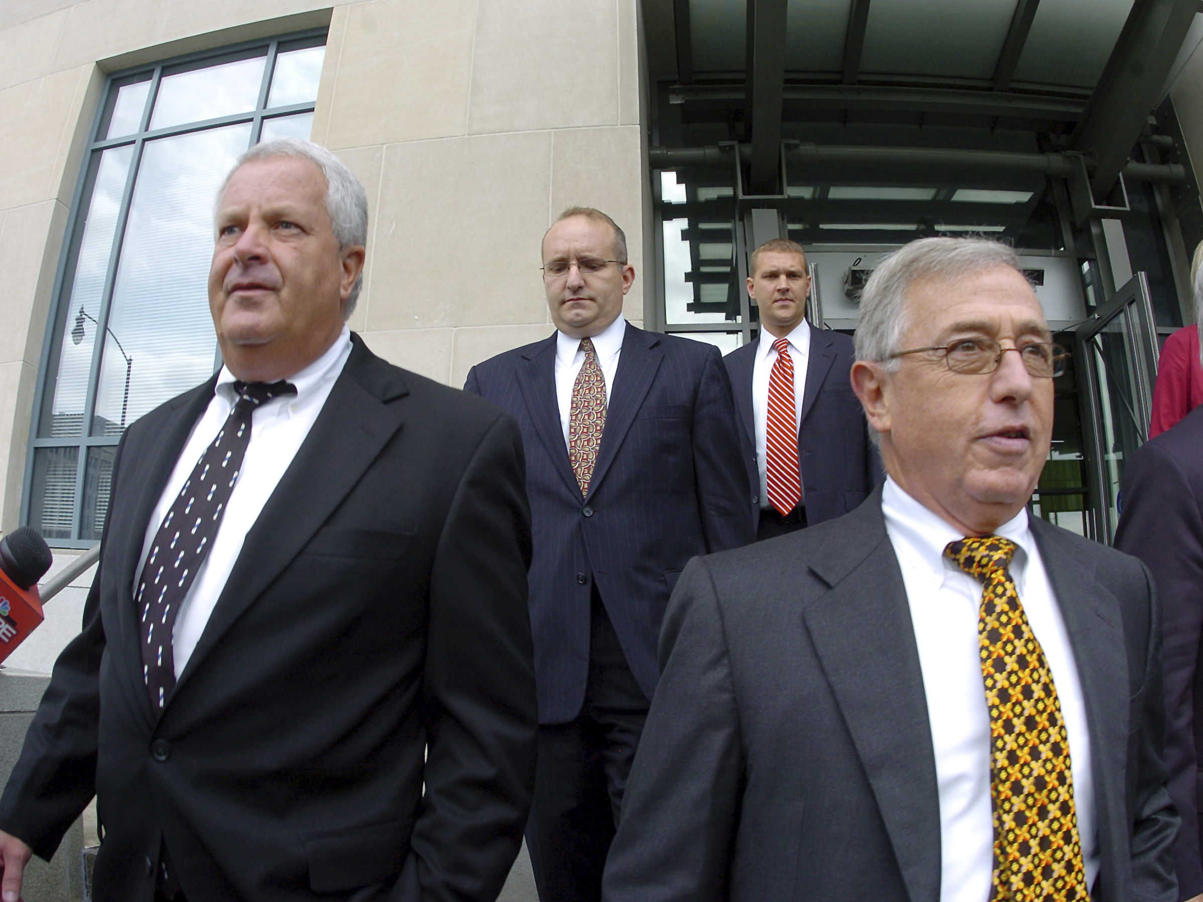 caption: Former Luzerne County Court Judges Michael Conahan, front left, and Mark Ciavarella, front right, leave the United States District Courthouse in Scranton, Pa., in 2009. The two Pennsylvania judges who orchestrated a scheme to send children to for-profit jails in exchange for kickbacks were ordered to pay more than $200 million to hundreds of children who fell victim to their crimes.