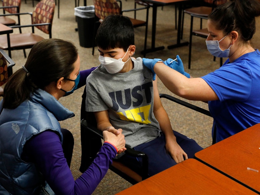 caption: Ari Blank got a comforting hand squeeze from his mom in May as he was vaccinated against COVID-19 in Bloomfield Hills, Mich. This week the U.S. Food and Drug Administration authorized the use of Pfizer's vaccine in even younger kids — ages 5-11.