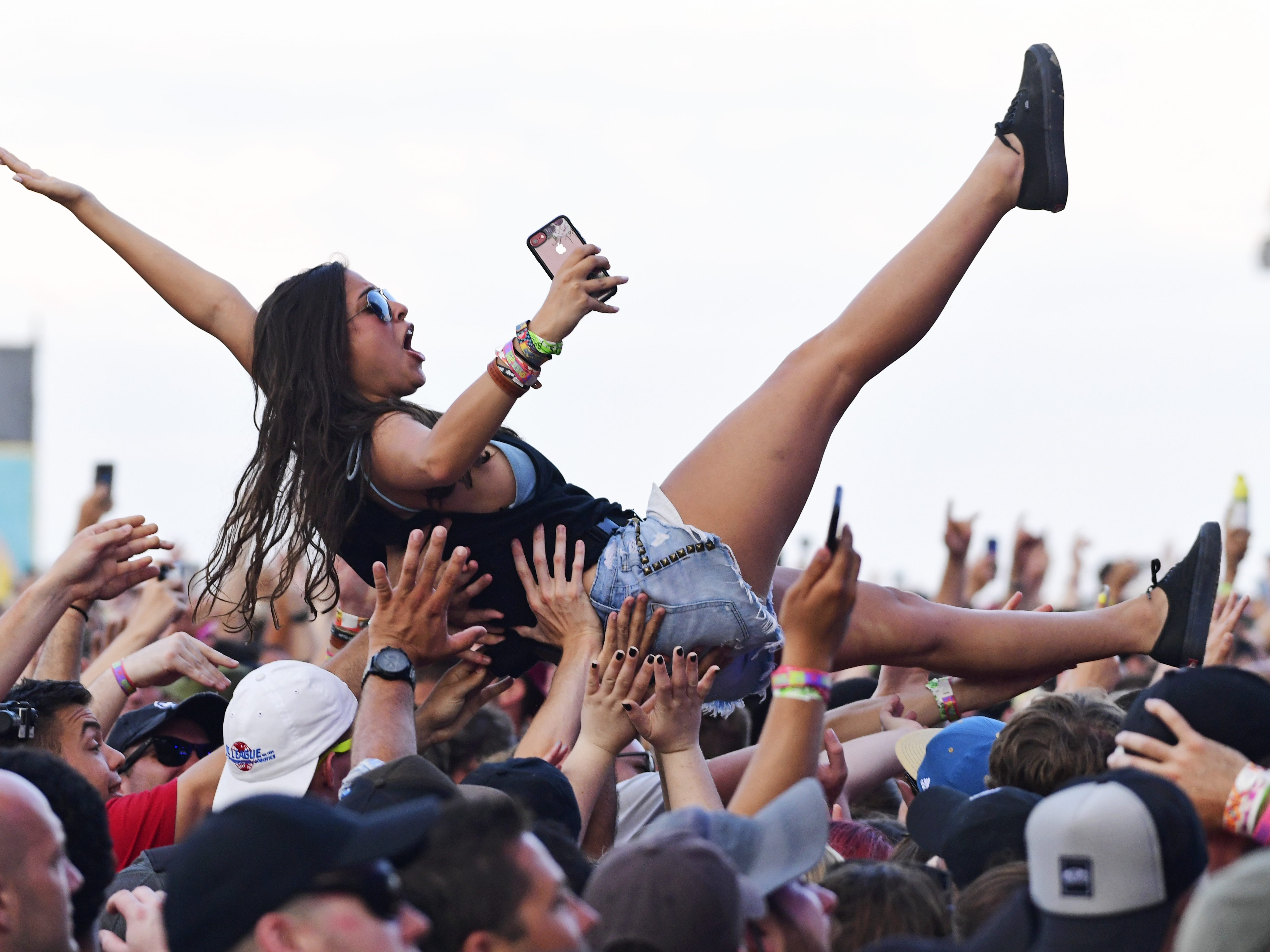 caption: ATLANTIC CITY, NJ - JUNE 30: A crowd surfer celebrates Taking Back Sunday's performance during the second and final day of Warped Tour on June 30, 2019 in Atlantic City, New Jersey. (Photo by Corey Perrine/Getty Images)