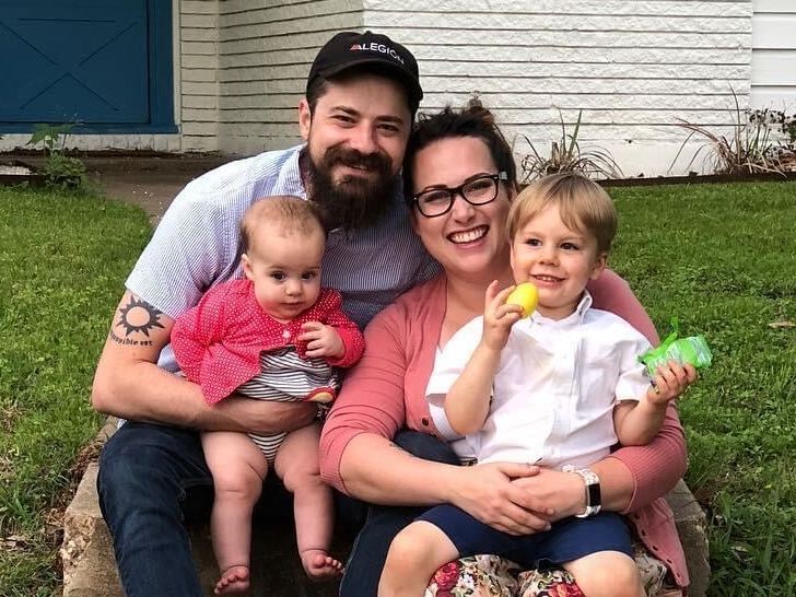 caption: Dan and Amanda Munro, with their children, Adelaide and Charles. Dan Munro found out he lost his job via a Zoom call.