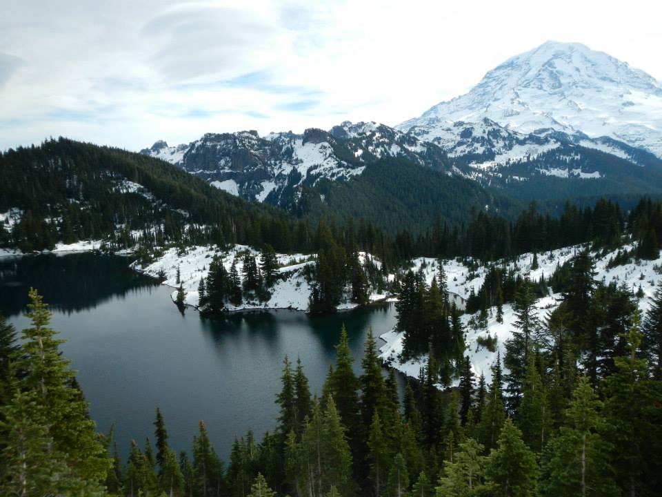 caption: Lake Mowich with Mount Rainier in the background had little snow in the beginning of the winter season. February is helping the Cascade Mountain range catch up with its snowpack.