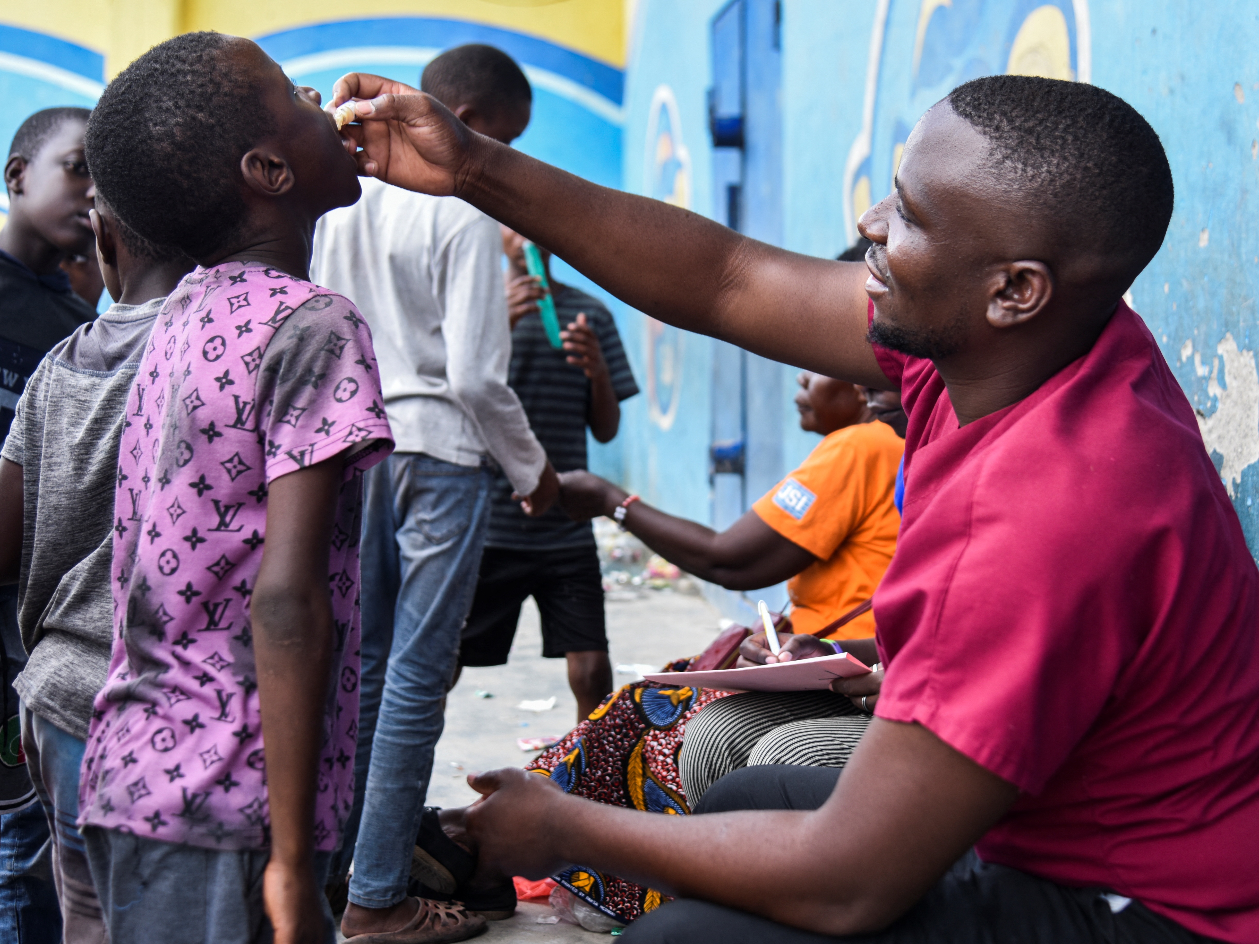caption: A child receives a cholera vaccine at a temporary treatment center during a past outbreak in Lusaka, Zambia.