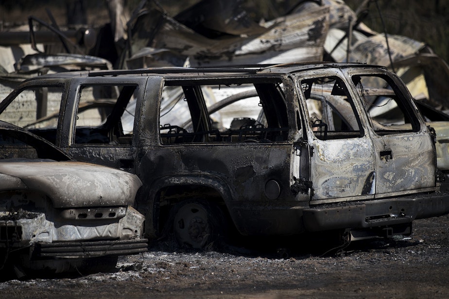 caption: Burned vehicles are shown on Wednesday, September 9, 2020, after a fire that started Monday evening burned 275 acres, including multiple homes and forced evacuations in the rural Pierce County town of Graham.