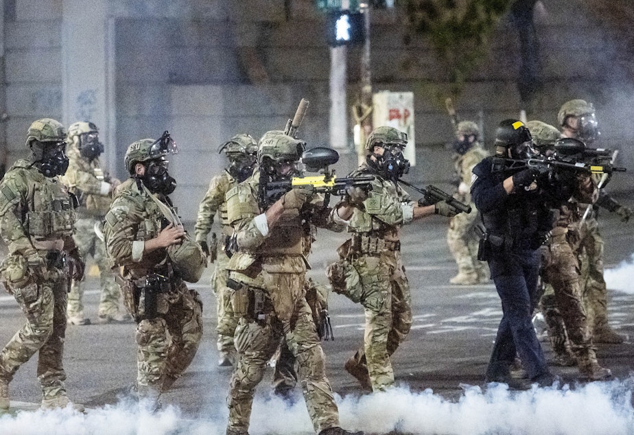 caption: Federal agents use crowd control munitions to disperse protesters at the Mark O. Hatfield U.S. Courthouse in Portland, Ore.
