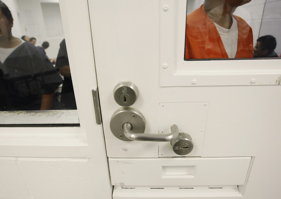 caption: Detainees are shown inside a holding cell at the Northwest Detention Center in Tacoma, Wash., Friday, Oct. 17, 2008. 