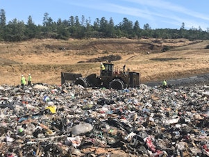 caption: Landfill workers bury all plastic except soda bottles and milk jugs at Rogue Disposal & Recycling in southern Oregon.