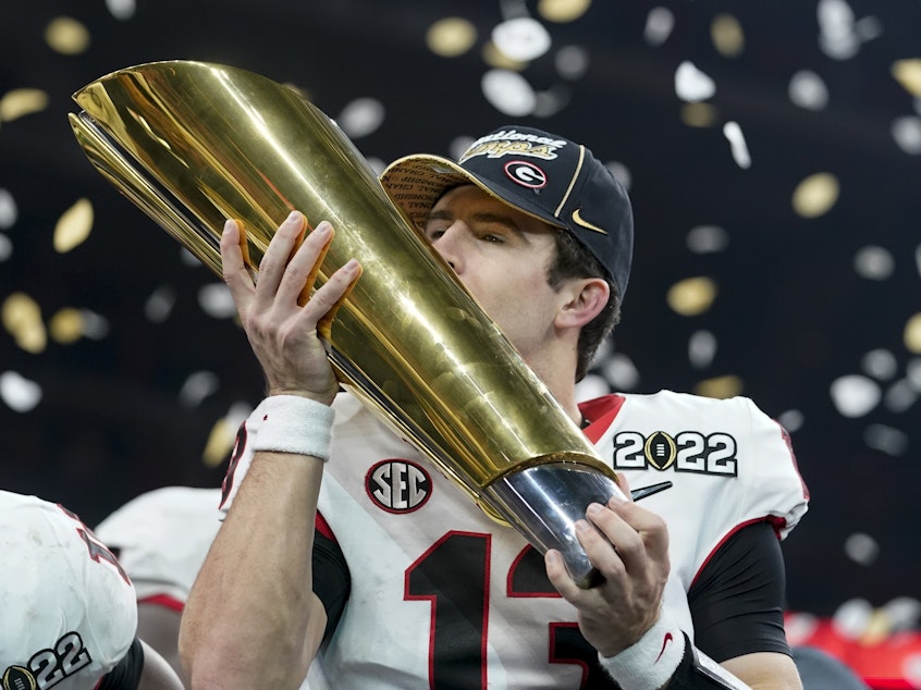 caption: Georgia's Stetson Bennett celebrates after the College Football Playoff championship football game against Alabama Tuesday in Indianapolis. Georgia won 33-18.