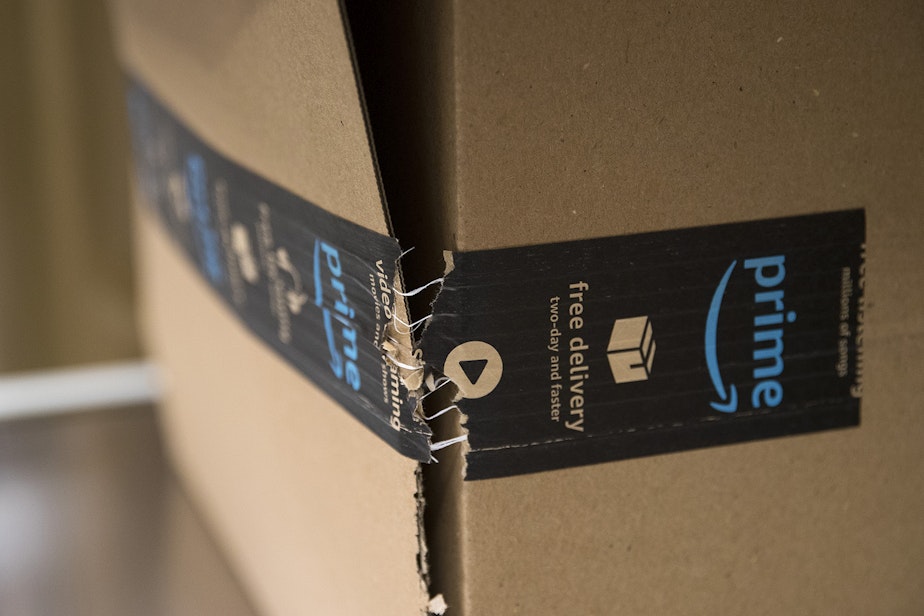 caption: An Amazon package is tested with a vertical compression tester on Tuesday, October 22, 2019, at an Amazon Packaging Lab in Seattle. 