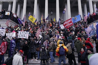 caption: Rioters take to the steps of the U.S. Capitol on Jan. 6. An NPR analysis found more Capitol riot defendants may have ties to the Oath Keepers, a far-right group, than was previously known.
