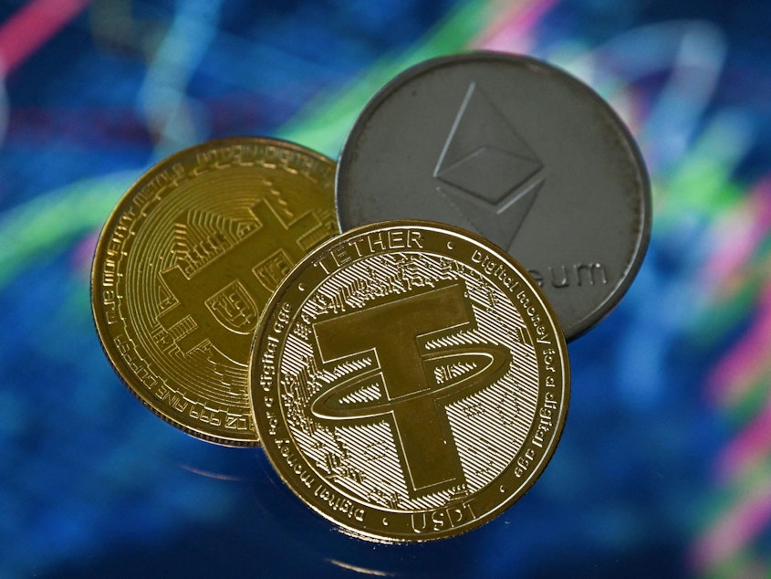 caption: BlockFi, a cryptocurrency lender, has filed for Chapter 11 bankruptcy. Here, an illustration picture shows gold plated souvenir cryptocurrency Tether, Bitcoin and Etherium coins.