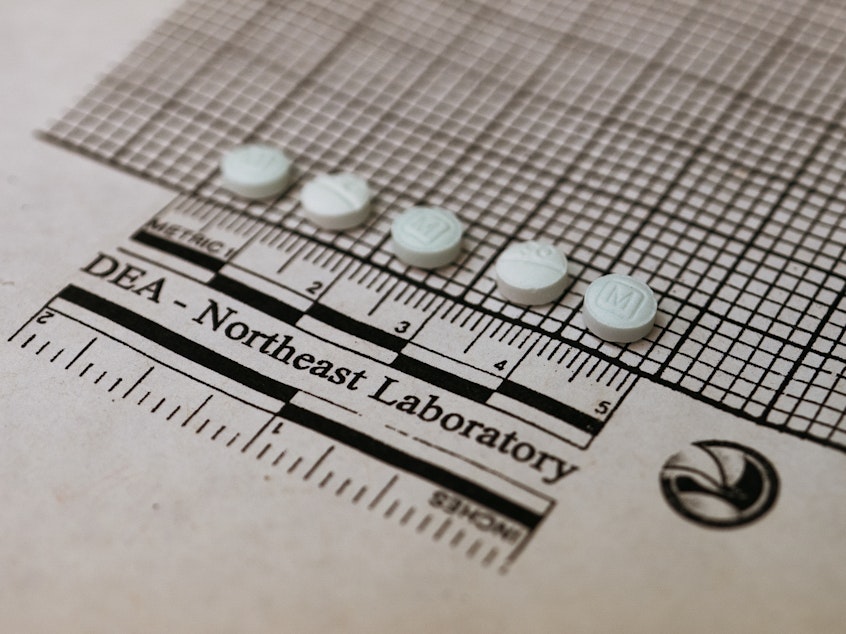 caption: Tablets suspected to be fentanyl are placed on a graph to measure their size at the Drug Enforcement Administration Northeast Regional Laboratory on October 8, 2019 in New York.