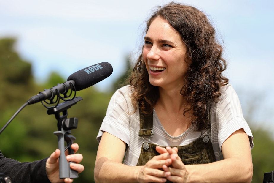 caption: Dr. Kaeli Swift, an avian researcher, speaking with KUOW's Seattle Now podcast in Seward Park.