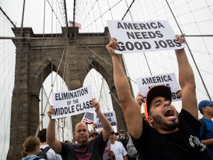 Following a rally in Brooklyn's Cadman Plaza Park, hundreds of union members march across the Brooklyn Bridge in support of IBEW Local 3 (International Brotherhood of Electrical Workers), September 18, 2017, in New York City.