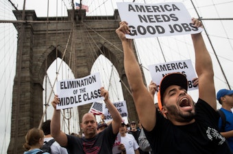 Following a rally in Brooklyn's Cadman Plaza Park, hundreds of union members march across the Brooklyn Bridge in support of IBEW Local 3 (International Brotherhood of Electrical Workers), September 18, 2017, in New York City.