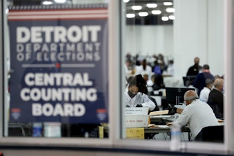 caption: Detroit election workers work on counting absentee ballots for the 2020 general election at TCF Center on November 4, 2020 in Detroit, Michigan. (Jeff Kowalsky/AFP via Getty Images)
