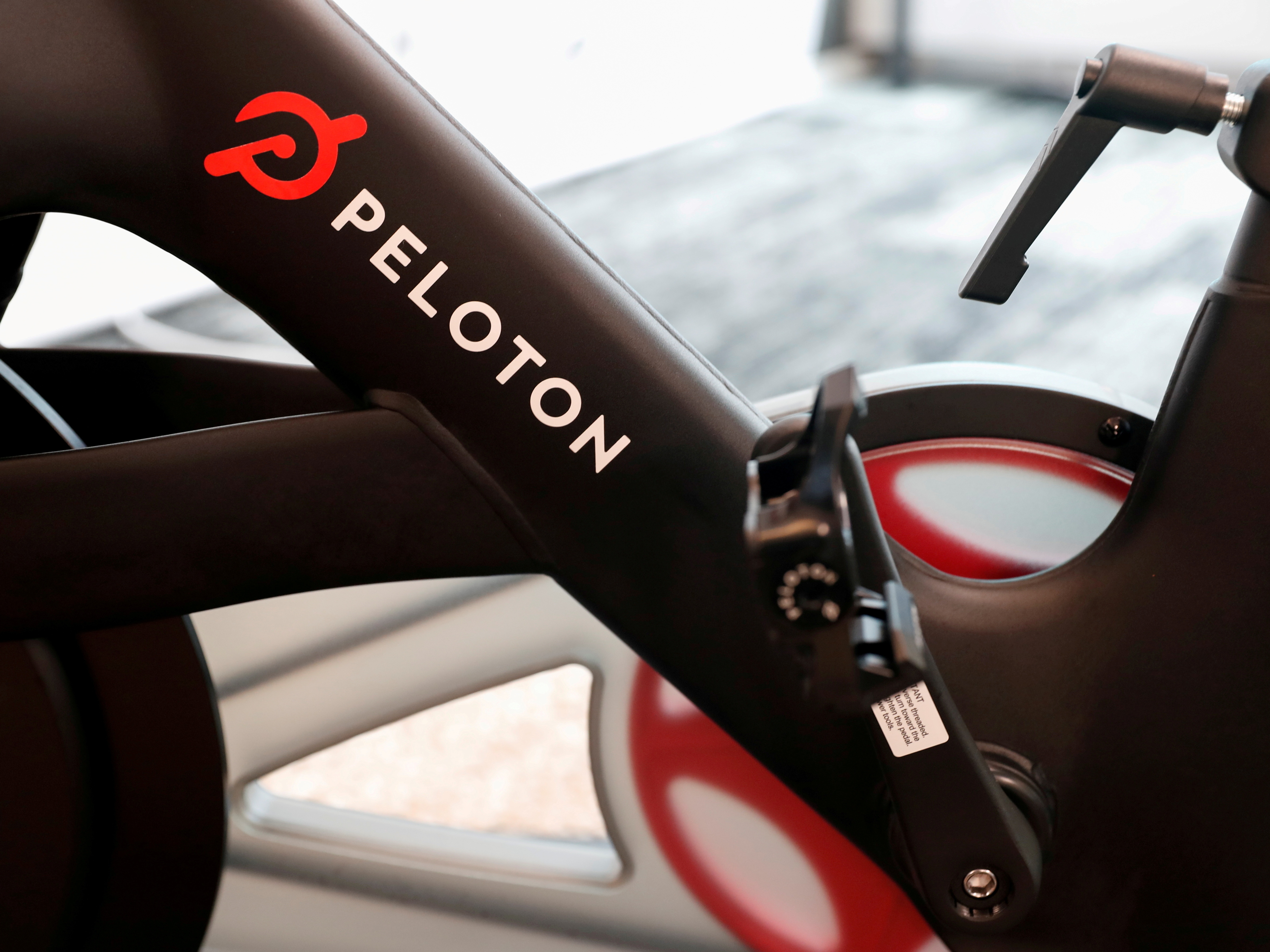 caption: Hackers can access a Peloton user's bike camera, microphone and screen, McAfee reported.