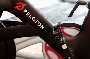 caption: Hackers can access a Peloton user's bike camera, microphone and screen, McAfee reported.