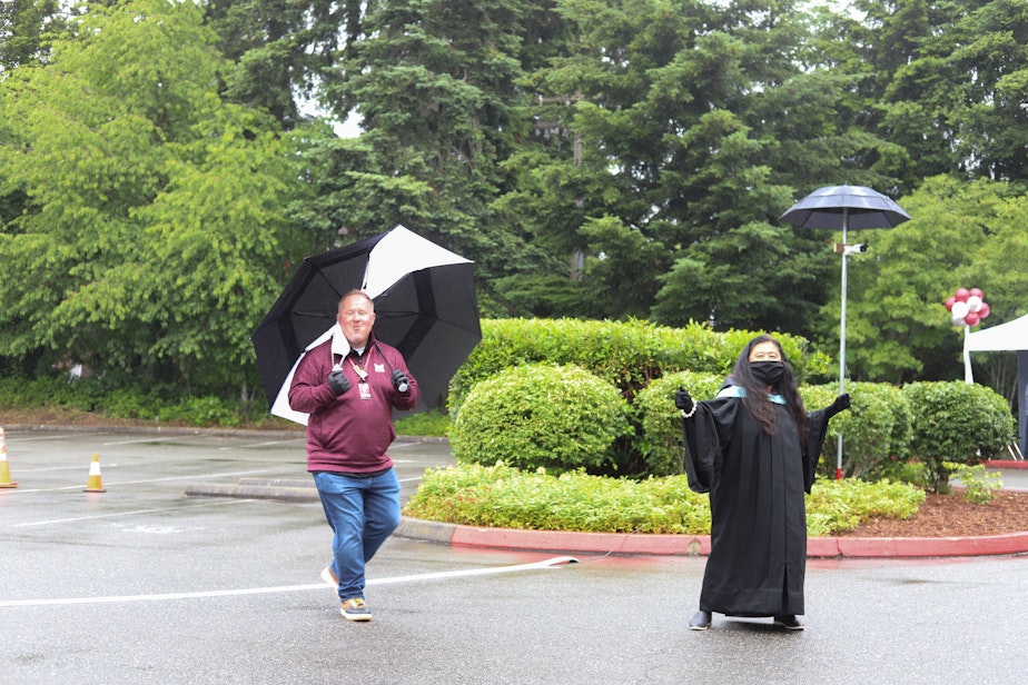 caption: On June 9, 2020, Mercer Island High School Graduation Day, Associate Principal Nick Wold, left, and Principal Vicki Puckett dance in the parking lot as they wait for cars to arrive as part of the drive-through graduation. “Hit the Road Jack” blasts from the speakers as Wold and Puckett celebrate seeing their senior students for the first time in months.