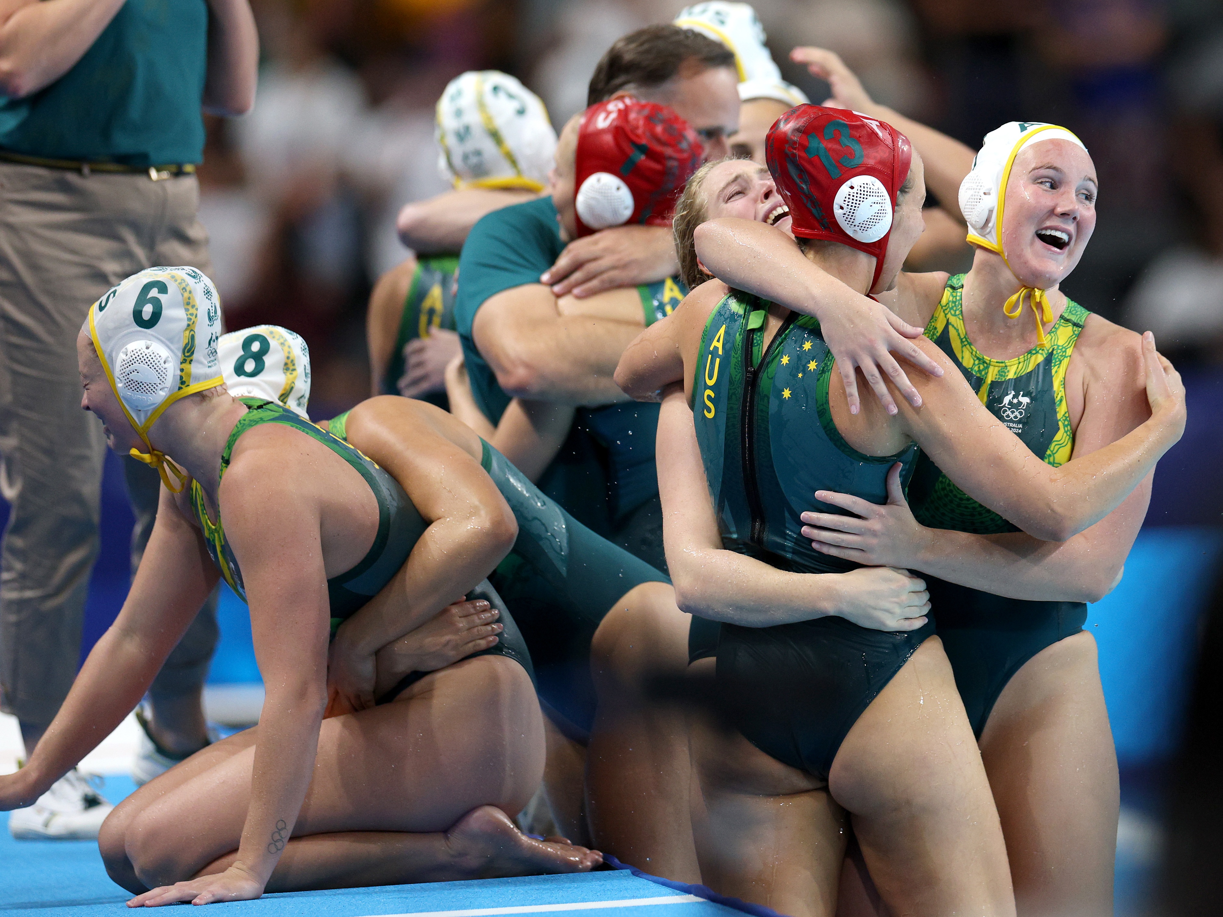 caption: Members of Team Australia celebrate victory following the penalty shoot out in the Women's Semifinal match between Team Australia and Team United States on day thirteen of the Olympic Games Paris 2024 at Paris La Defense Arena on Aug. 8 in Nanterre, France.