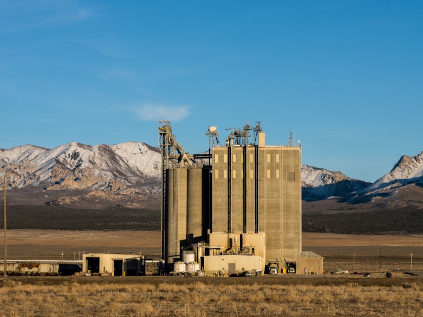 caption: The Smithfield feed processing mill producing food for nearby hog-raising farms in Milford, Utah.