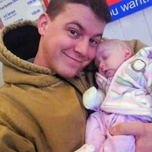 caption: Jeremy Lavender with his newborn daughter in 2009.