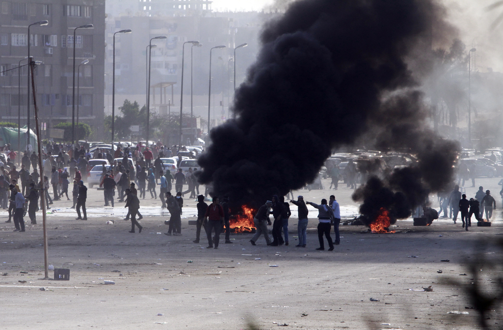 caption: Supporters of ousted President Mohammed Morsi damage an area on a street as they protest against the government in Cairo's Nasr City district on Friday. 