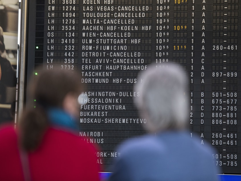 caption: A destination board shows canceled flights at Frankfurt Airport in Germany last month. The coronavirus pandemic has disrupted travel plans for refugees who'd been granted asylum in various countries.