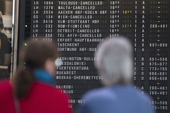 caption: A destination board shows canceled flights at Frankfurt Airport in Germany last month. The coronavirus pandemic has disrupted travel plans for refugees who'd been granted asylum in various countries.