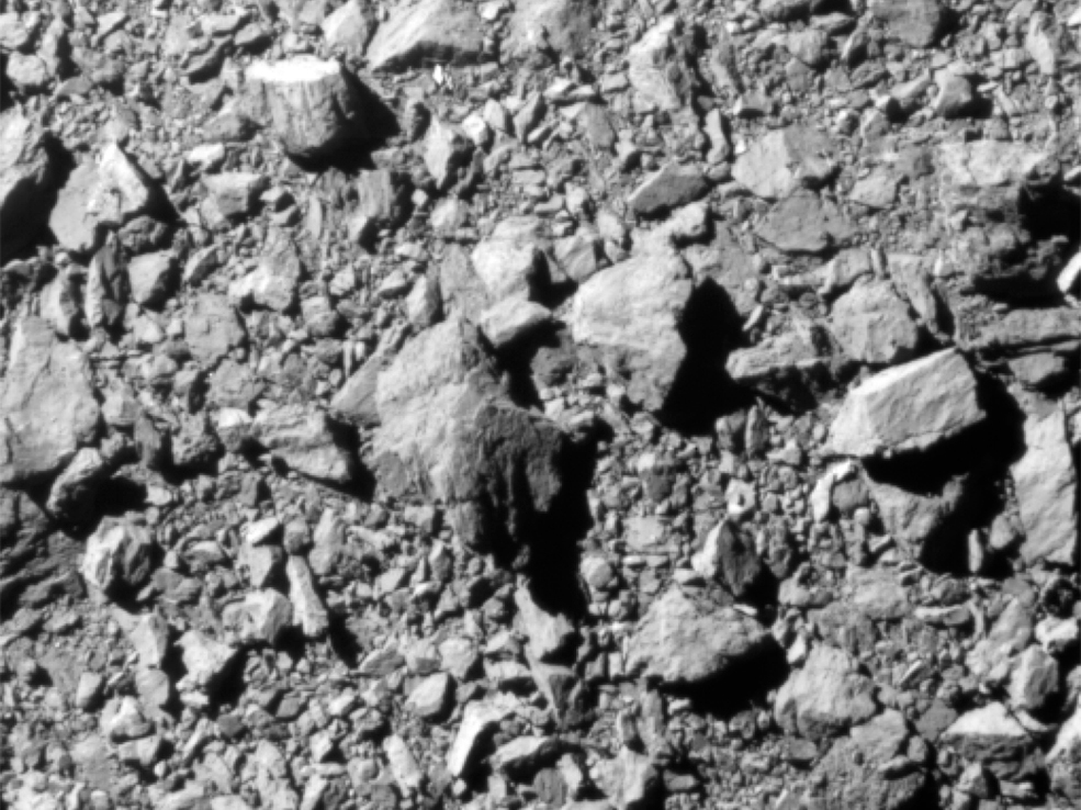 caption: This is the last complete image of Dimorphos taken by the DRACO imager on NASA's DART mission before the collision. It shows a patch of the asteroid about 100 feet across, captured from some seven miles away and two seconds before impact.