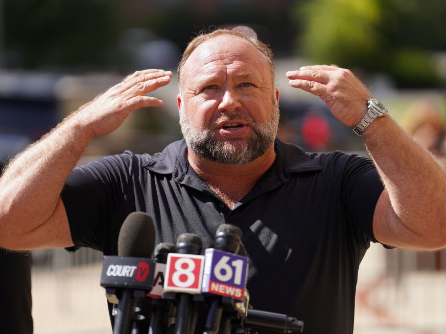 caption: InfoWars founder Alex Jones speaks to the media outside Waterbury Superior Court during his trial on September 21, 2022 in Waterbury, Connecticut in which he was being sued by several victims' families for causing emotional and psychological harm after they lost their children in the Sandy Hook massacre.