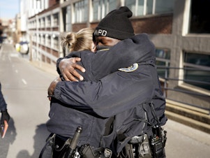 caption: Nashville Police officers Brenna Hosey, left, and James Wells embrace after speaking at a news conference Sunday in Nashville. Hosey and Wells are part of a group of officers credited with evacuating people before an explosion took place in downtown Nashville early Christmas morning.