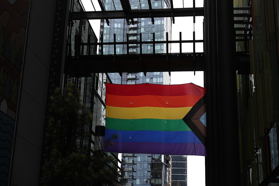 caption: A pride flag is displayed outside of Amazon's Doppler building on Wednesday, June 1, 2022, in Seattle. Trans Amazon workers and allies staged a "die-in" protest as the company began the Pride flag raising ceremony. 