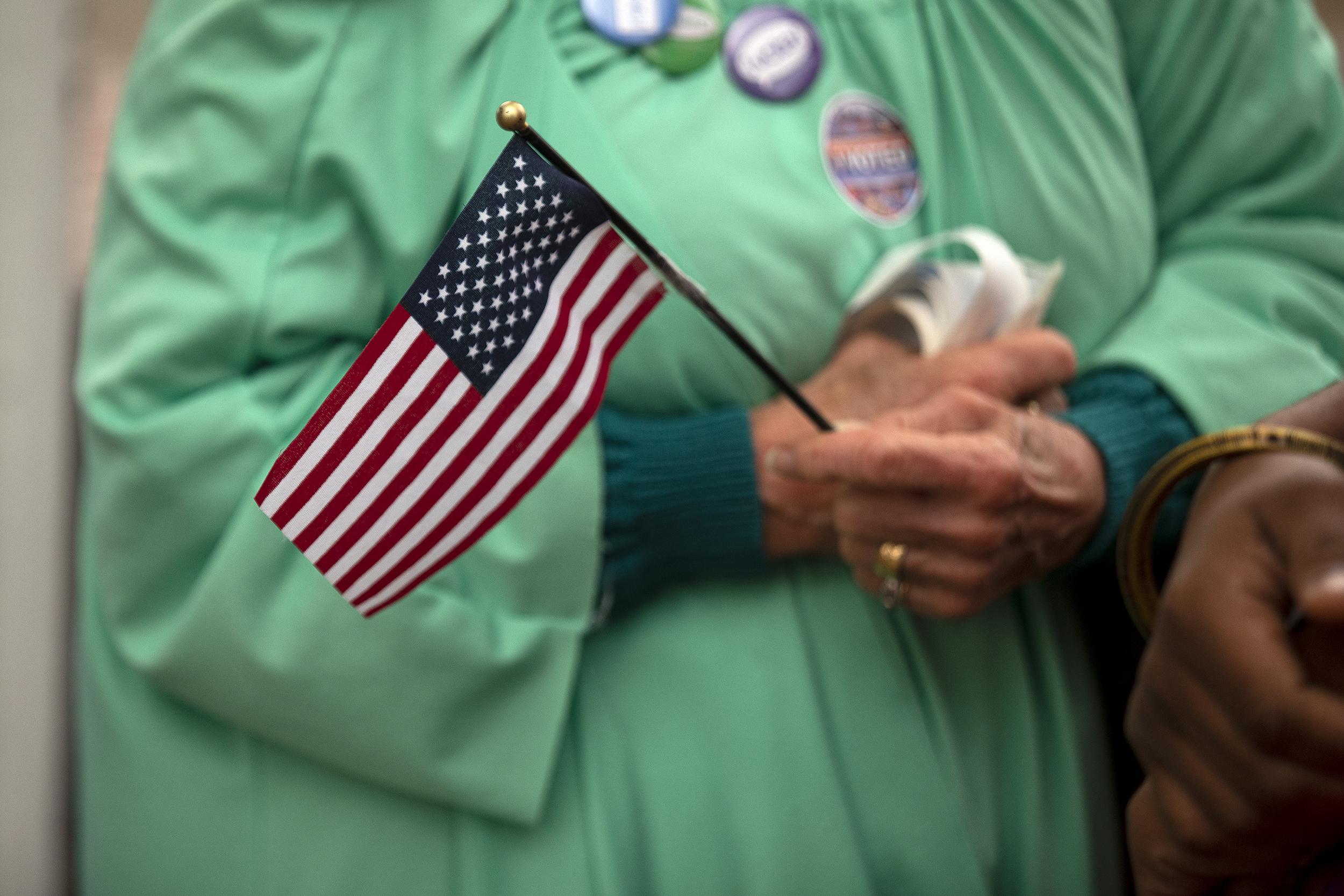 caption: Patti Gorman, dressed as lady liberty, talks with her former Seattle Central student, Afrikaan Sahra, right, as voters cast their ballots on Tuesday, November 5, 2024, outside of Seattle Central College in Capitol Hill. Sahra is voting for the first time after receiving U.S. citizenship. 