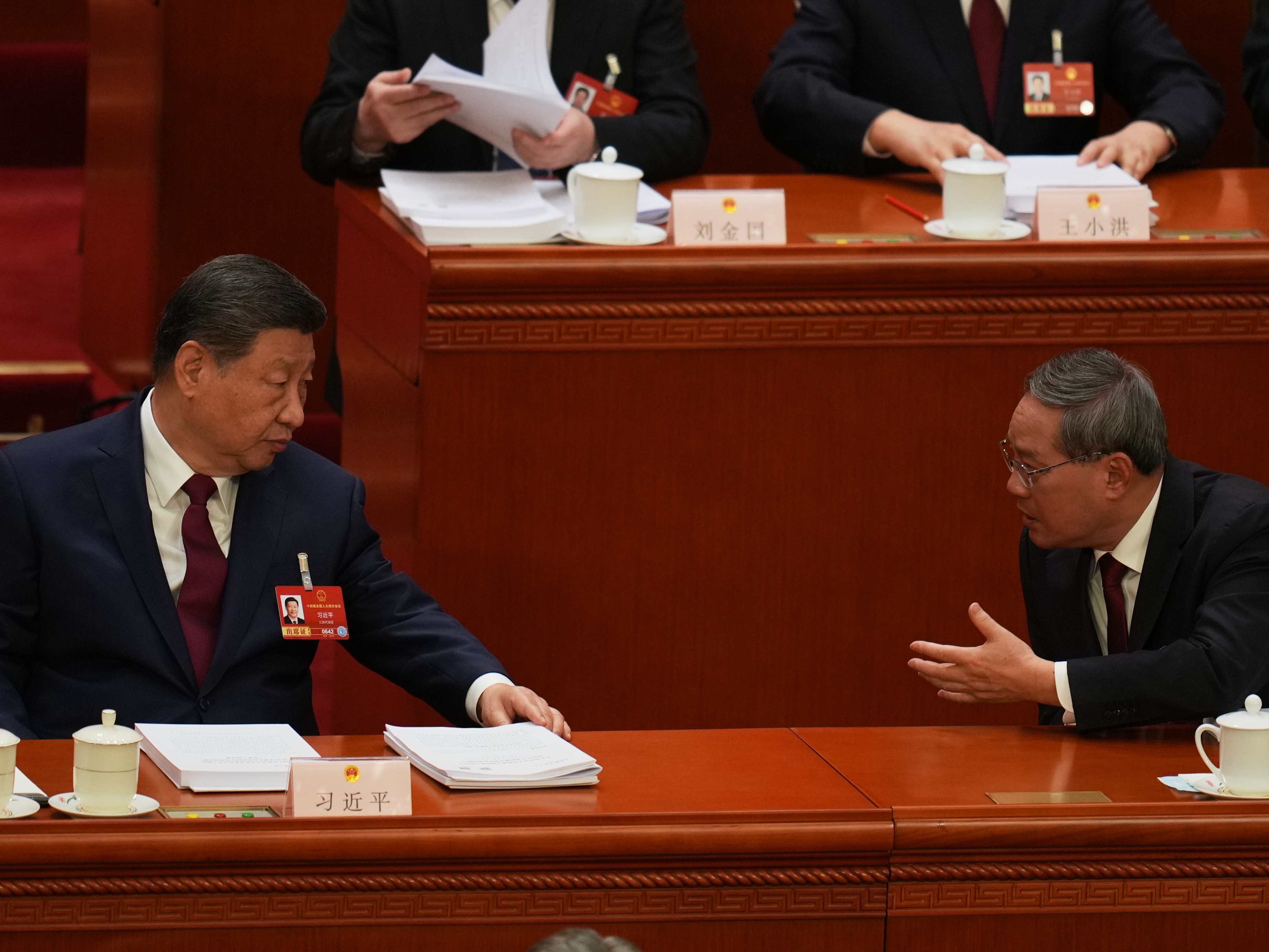 caption: Chinese President Xi Jinping, left and Chinese Premier Li Qiang chat during the opening session of the National People's Congress (NPC) in Beijing, Thursday, March 5, 2026.