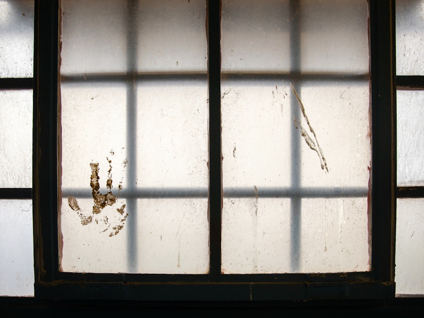 caption: A handprint stained on the window at the Navajo Nation Detention in Shiprock, N.M., on April 13, 2021.