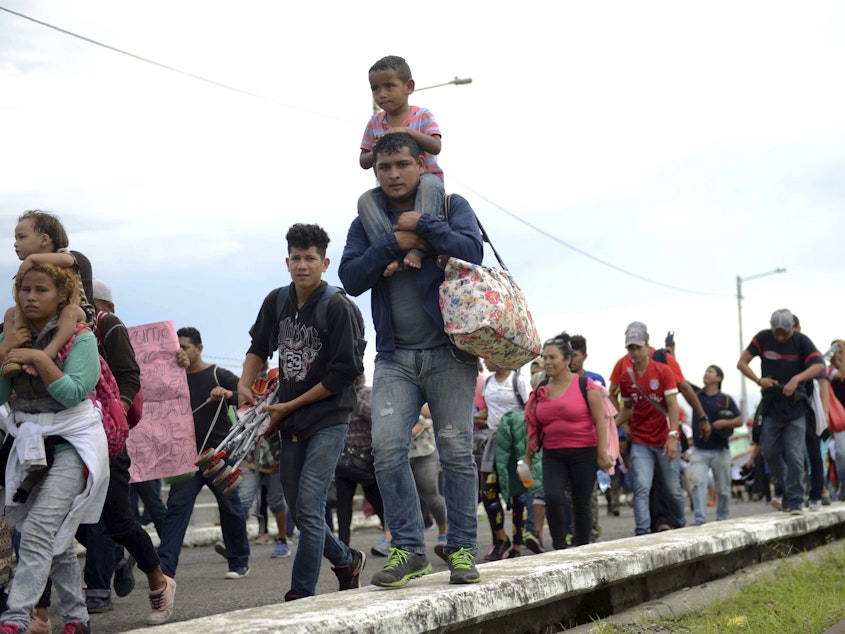 caption: Thousands of Honduran migrants and families walk towards the southern Mexico border from Guatemala. Many say they are headed to the U.S. The White House said on Tuesday that a record number of migrant families have arrived at the Southwest border over the last year.